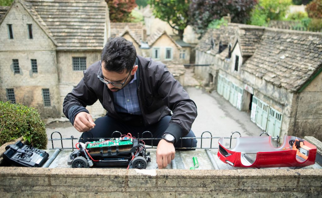 Bramble Energy’s Chief Operating Officer, Vidal Bharath, prepares the hydrogen-powered model Mirai for its test drive at the Old New Inn model village.