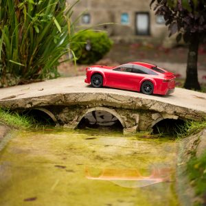 The mini Mirai cruises over a bridge outside the Motor Museum in the Old New Inn model village.