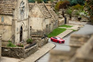 Tamiya’s miniature Mirai drives past the model village church in The Old New Inn model village.