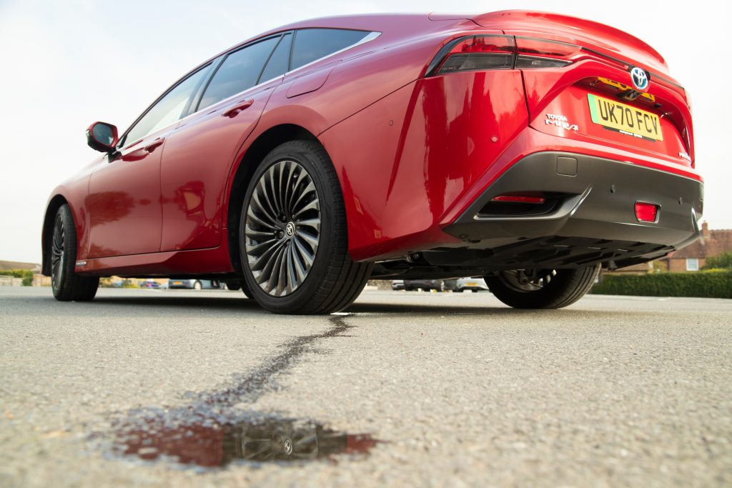 A small puddle of water - the only emissions made by the full-sized Toyota Mirai hydrogen fuel cell car, pictured here.