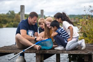 Steve Backshall introduces a group of children to pond dipping.