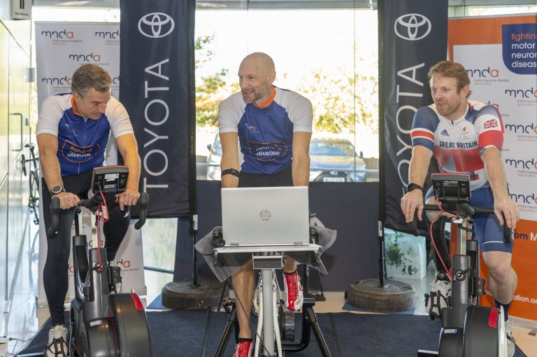 Greg Culshaw during his cycle challenge, joined by Agustin Martin, Toyota (GB) President and Managing Director (left) and Paralympic champion, Jody Cundy (right)