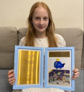 Katie Moiseeva with her Toyota Dream Car Art global winner certificate