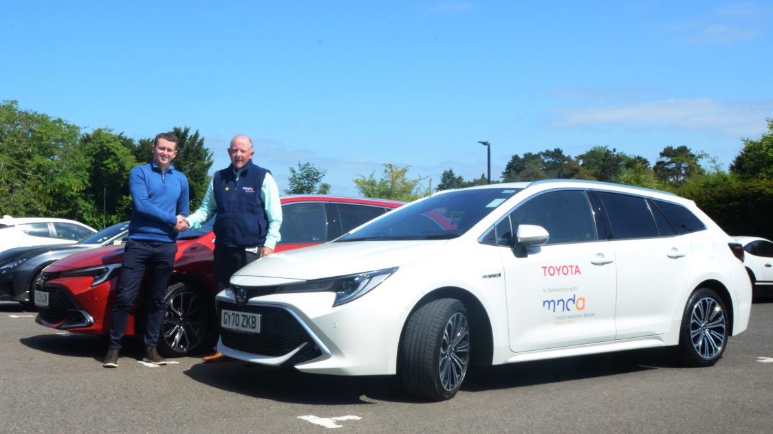 Ryan Luscombe, Specialist, Toyota GB CSR programmes, hands over a Corolla Touring Sports loan car to Phil Day, Facilities Manager for the MND Association