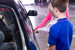 Scene from Toyota film: children using a key to open the 1992 Carina E. www.rkpphotography.co.uk.