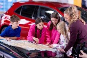 Scene from Toyota film: children use a map on the bonnet of the Carina E to find out how to get to Alton Towers. www.rkpphotography.co.uk.