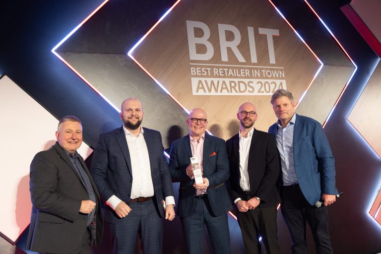 From L to R: Mark Roden, Toyota (GB) Operations Director, with winners of the Toyota Retailer of the Year award, Toyota Peterborough - and TV presenter Mark Durdan-Smith